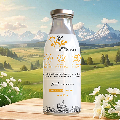 Milk bottle packaging design for Heifer fresh farm milk placed against a scenic countryside landscape with mountains and green fields in the background.